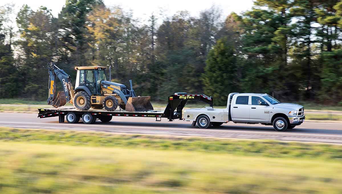 FWF Hauling - Truck hauling heavy equipment on highway